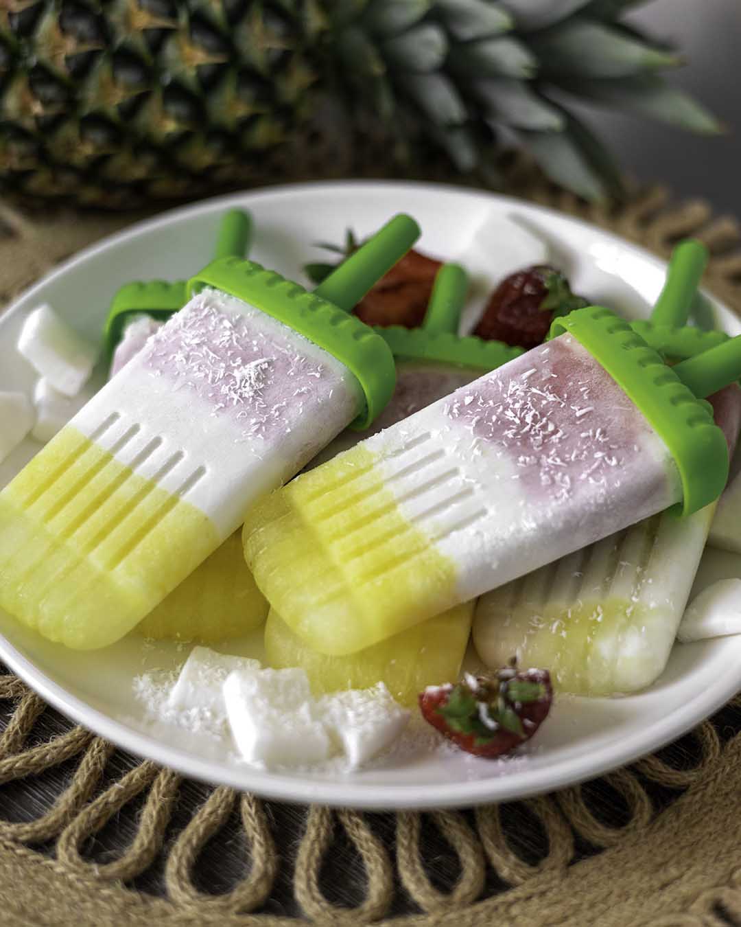 pina colada popsicles on white plate