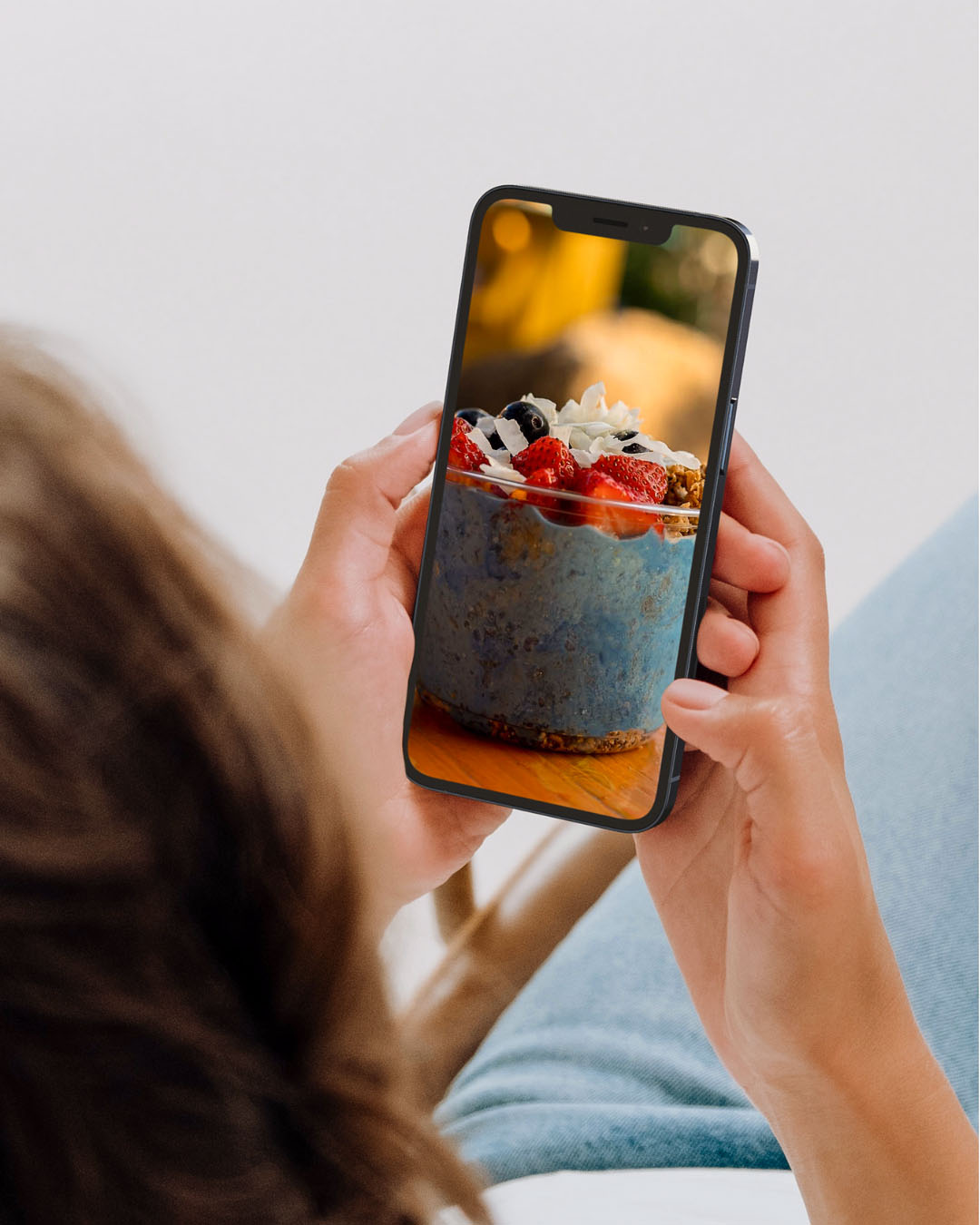 girl taking photo of food on phone