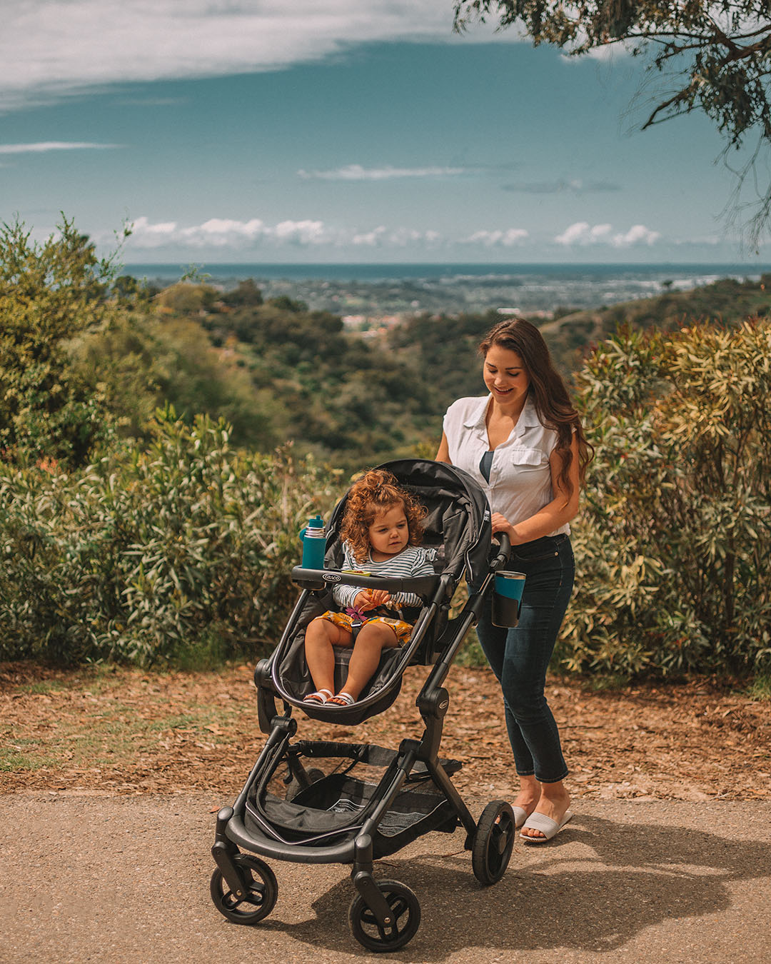 mom pushing toddler in stroller