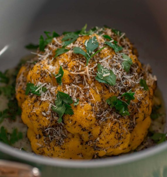 Whole Roasted Cauliflower up close with fresh parsley